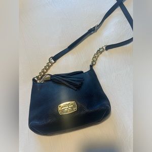 Michael Kors leather crossbody purse with adjustable strap.